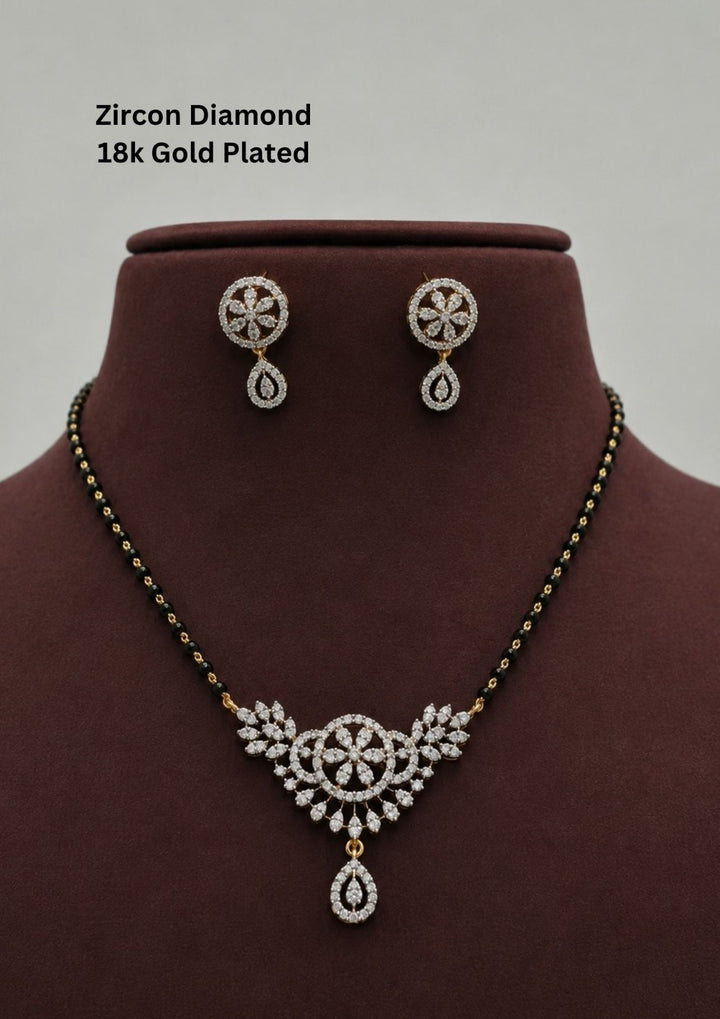 Gold plated black beads mangalsutra featuring an elegant Classic Black Beaded -inspired zircon centerpiece with delicate curved detailing. Lightweight and beautifully crafted for everyday elegance, festive occasions, and gifting.